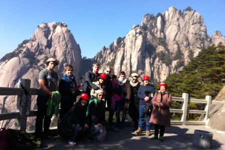 Students posing in front of a mountian in China