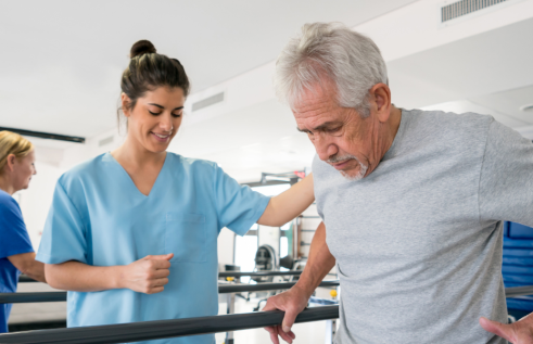 Stock image of an occupational therapist working with an elderly man