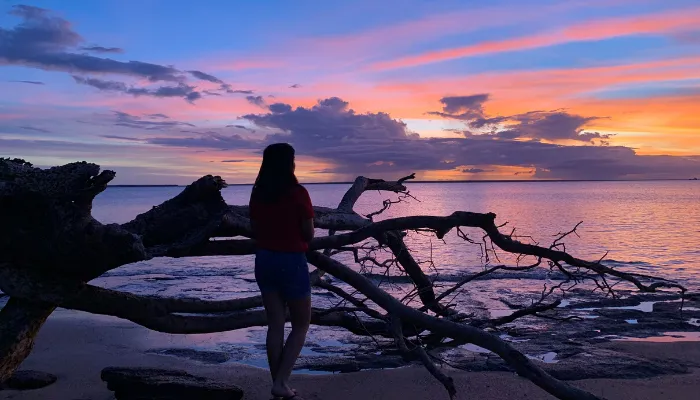 CDU student Srijana Ghimire watching the sunset on a beach