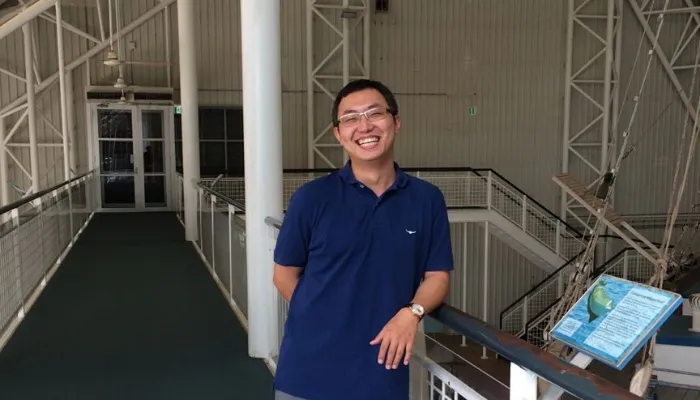Electrical engineer Hao smiles at the camera