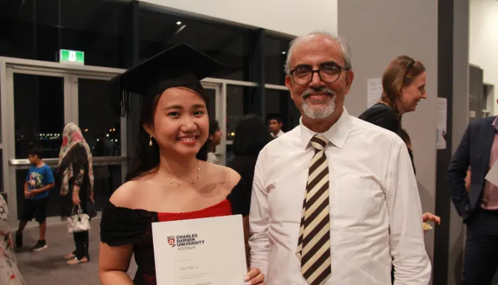Erika holding her graduation certificate