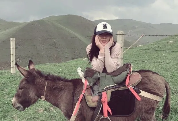 Chengxi Li sitting on a donkey