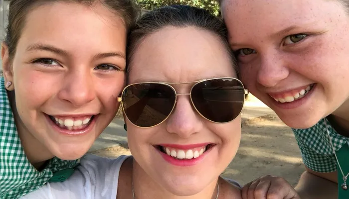 Elizabeth smiling with her two children