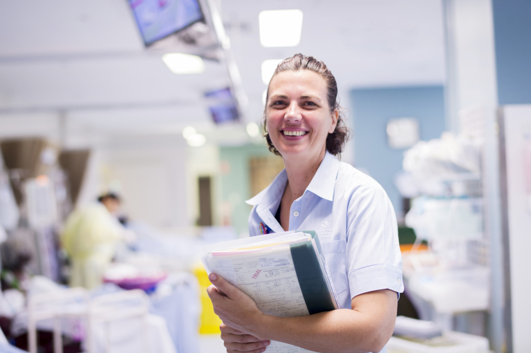 A smiling nurse in a hospital ward