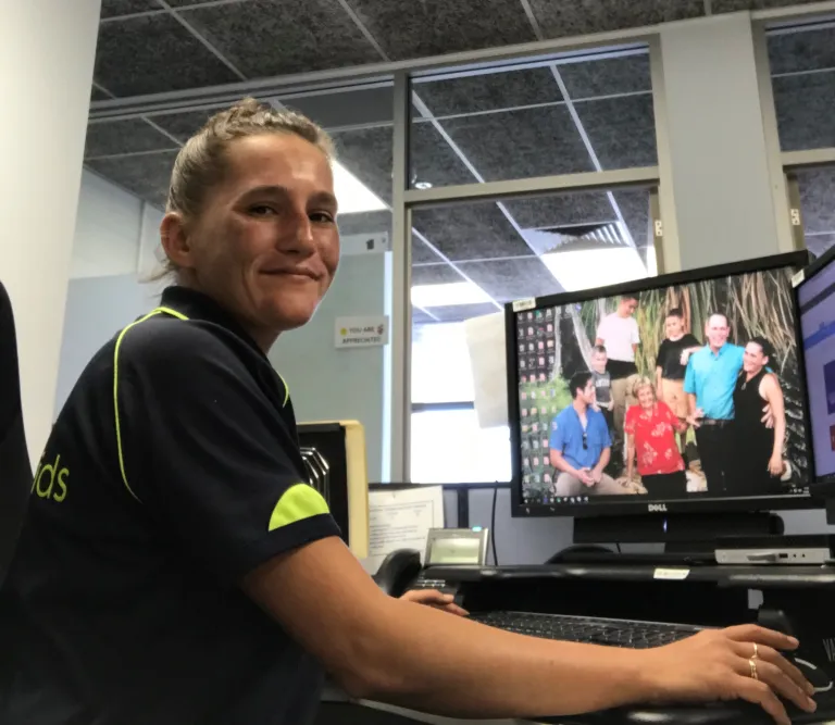 Debra at her computer smilling