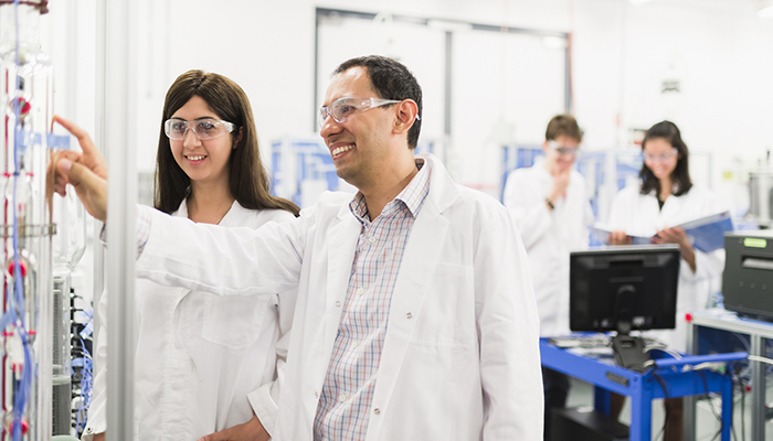 Engineering Lecturer and student in lab