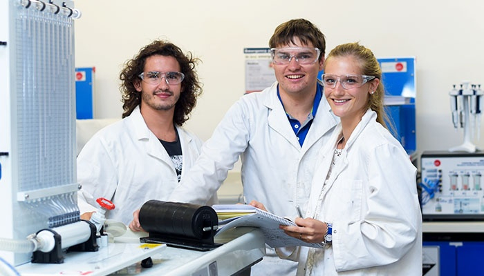 Three CDU engineering students in a laboratory environment