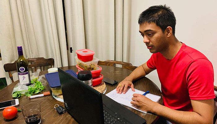 Bijay Lamsal studying in front his laptop