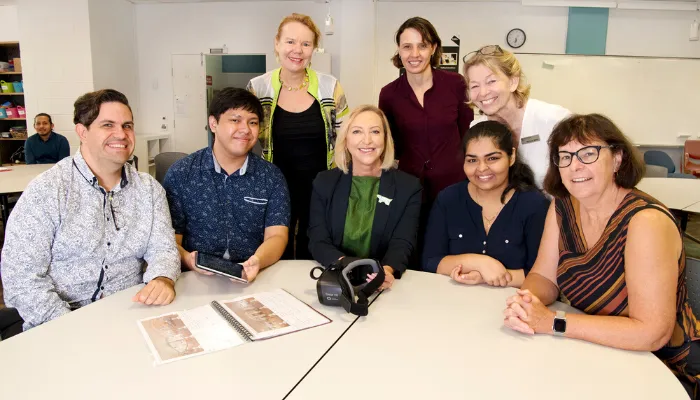 Reema smiling with her colleagues