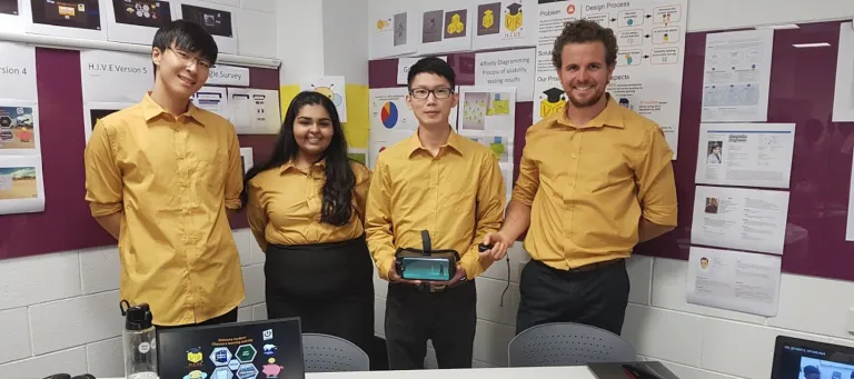 Reema smiling with her colleagues