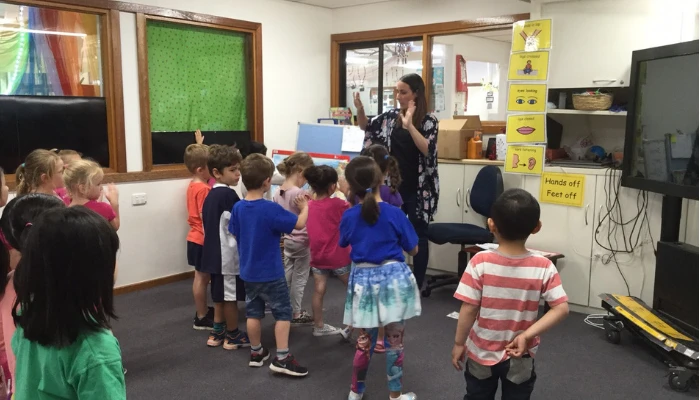 Sallie in the classroom surrounded by children