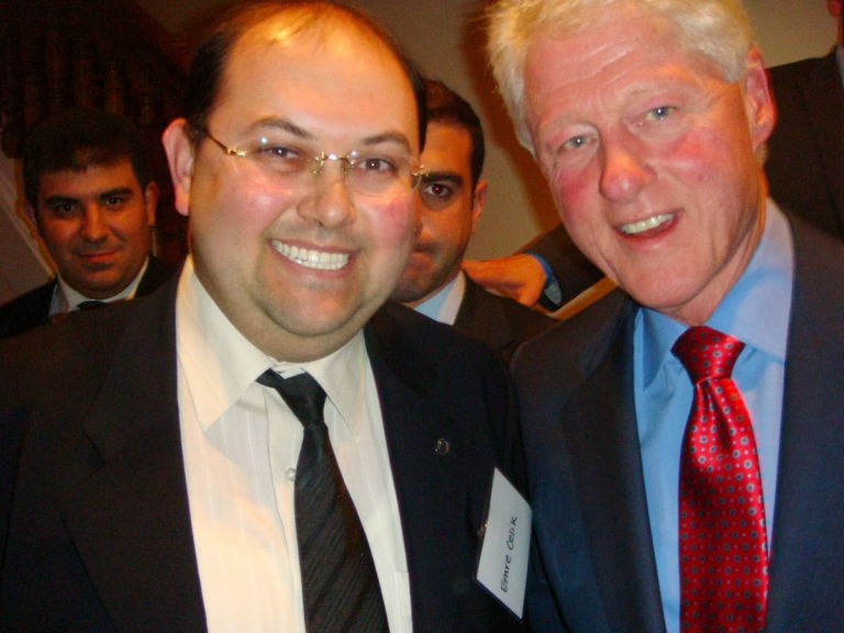 Emre smiling with Bill Clinton