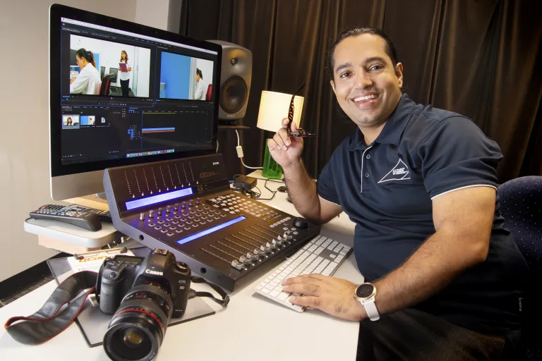 BP smiling next to his filmmaking equipment