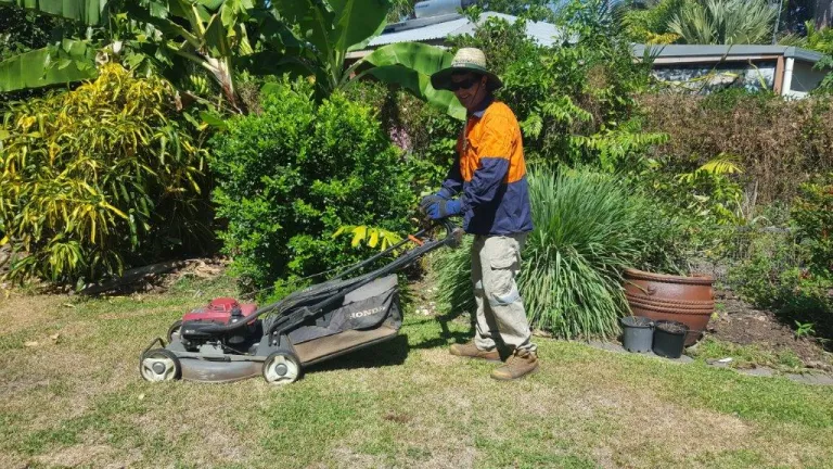 Jojo smiling while mowing lawn 
