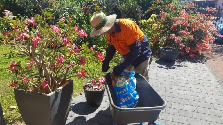 John preparing potting mix for flower pots