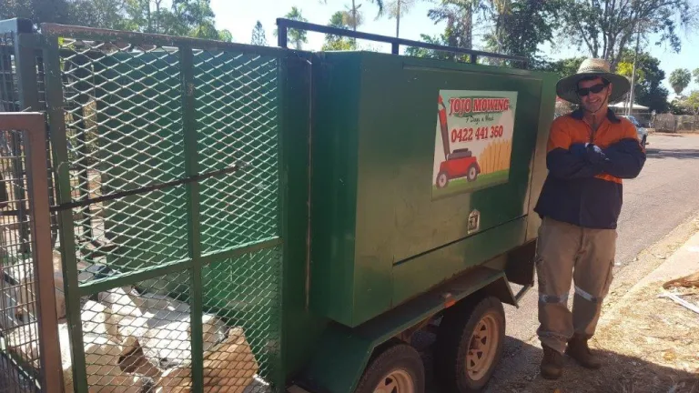 John smiling in front of his business vehicle