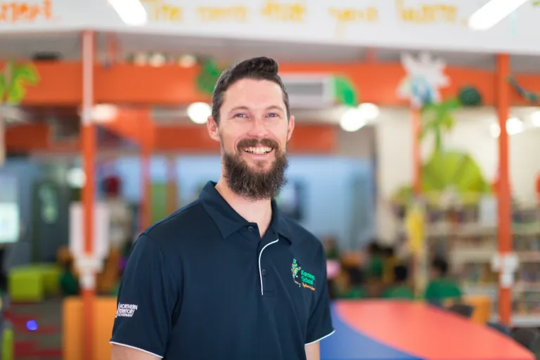 Portrait of a male teacher in a classroom