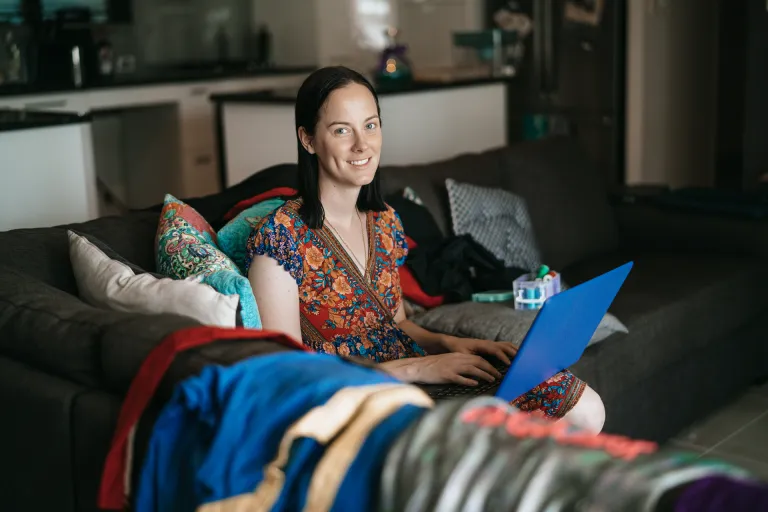 CDU student Malia studying online on her couch