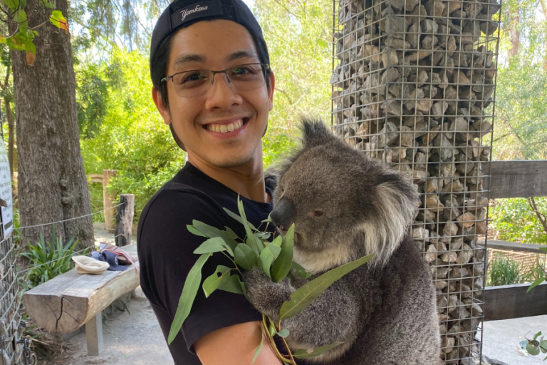 International student Lloyd holding koala