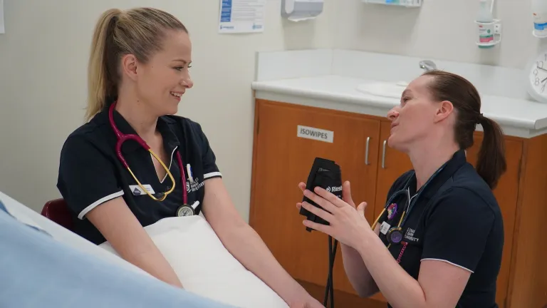 alicia burrows getting heart rate checked by coworker