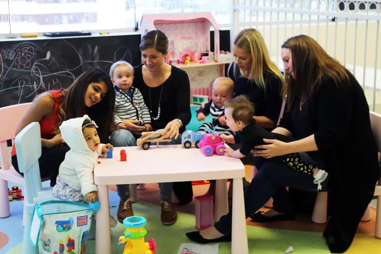 Alica Burrows plays with mothers and children 