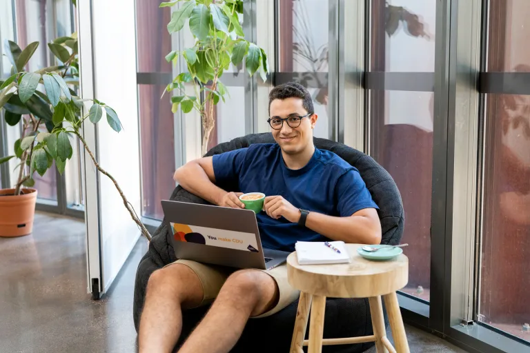Student studying on laptop in cafe