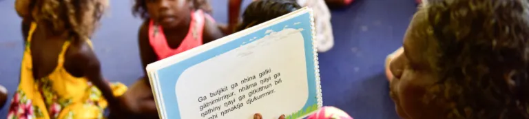 Aboriginal woman reading to children