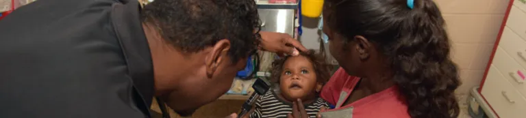 Man and woman looking at infant