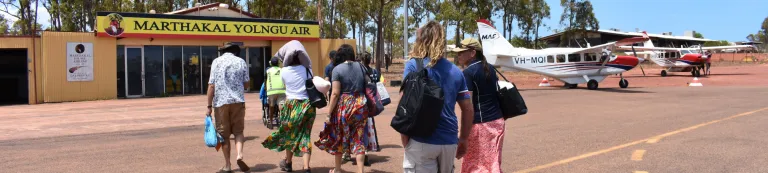 Group walking towards Marthakal Yolngu Air building