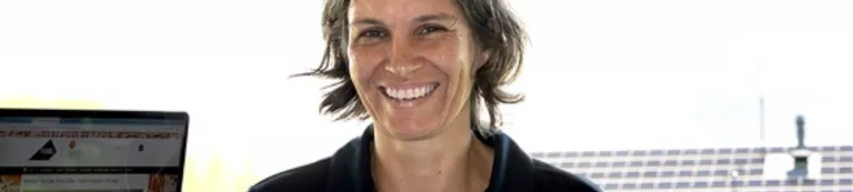 NI staff member posing with laptop