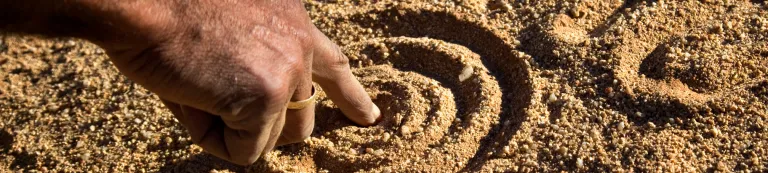 A hand drawing in the sand