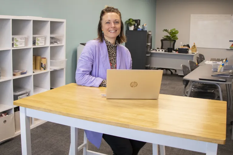 Hannah at desk in her classroom