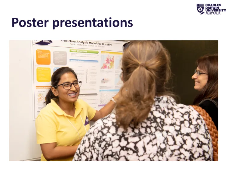 a woman next to a poster explaining it to visitors