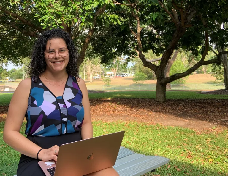 Law student Sekari on campus using laptop