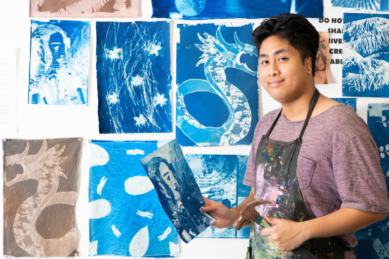 Creative arts student with artworks