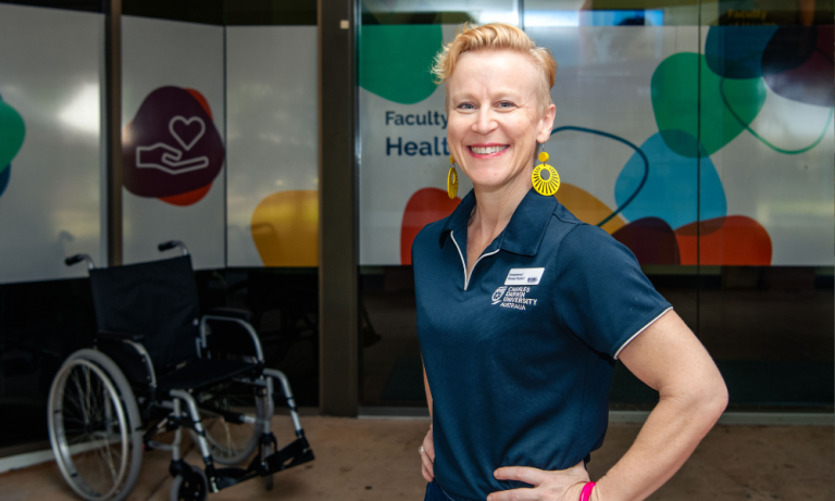 Occupational therapy student Lana outside Faculty of Health with wheelchair