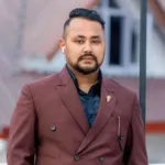 Om G C MPP Student young man smiling with maroon suit