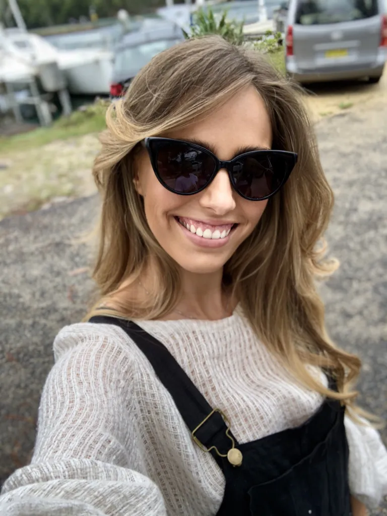 Woman with sunglasses smiling at camera