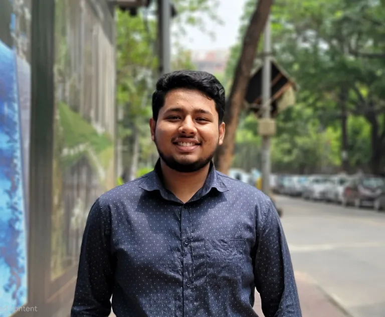 Man wearing dark blue shirt smiling at camera