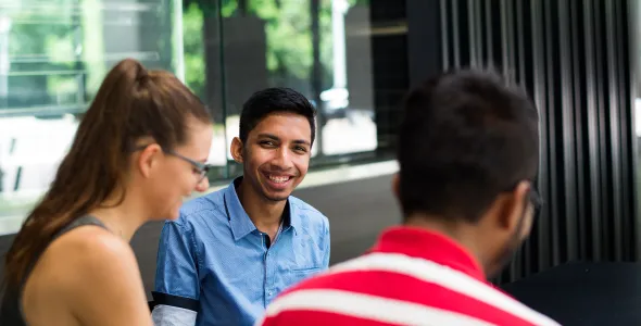 Three students talking in a group