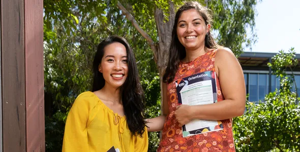 Two female international students smiling