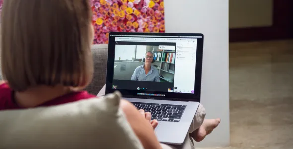 Woman studying online with nurse on video