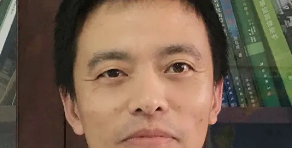 Prof. Jian Zhang face, with books in background