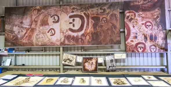 Copies of archival materials exhibited at the Wilinggin Shed in July 2022 with portraits in front and prints of rock art copies in the back