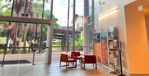 foyer of Menzies Building Red 9 at Campus - large internal building with glass windows and orange chairs