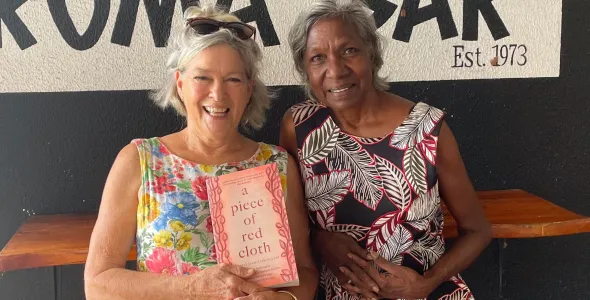 Co-authors Leonie Norrington and Merrkiyawuy Ganambarr-Stubbs smiling and holding their book