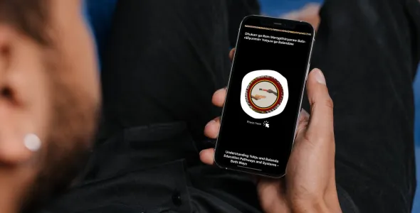 A young Indigenous Australian man looks at the Yolŋu Healthcare App on his phone