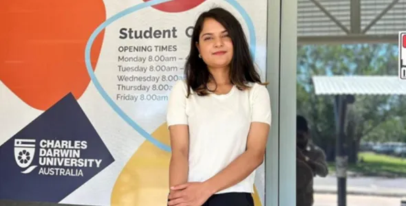 mpp female student stands in front of doors