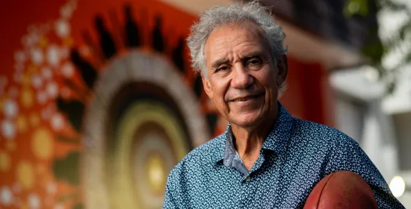 Charlie King holding a football