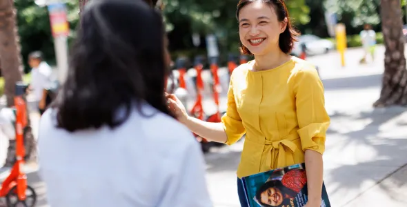 Image of a female student speaking to another student